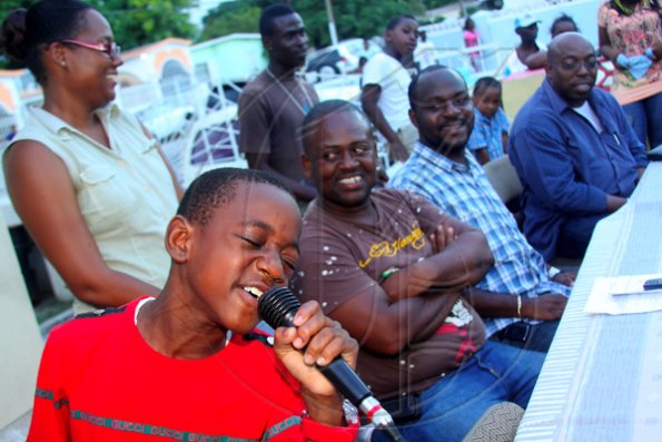Anthony Minott/Freelance Photographer
Joshua Blake, aka, Double Dose, a nephew of Councillor Keith Blake (second left), sings during a back-to-school project instigated by Councillor Blake of the Independence City Division recently.