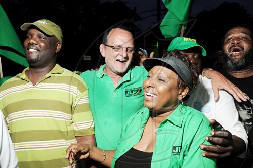 Ricardo Makyn/Staff Photographer                                  Jamaica Labour Party candidate Gregory Mair (second left), celebrates his victory in the North East St Catherine by-election with supporters, including Member of Parliament for Central St Catherine Olivia Grange (centre), in Riversdale yesterday.
