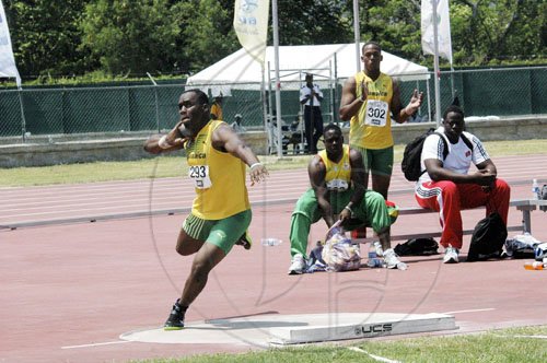 Adrian Frater photo
Jamaica's Ashinia Miller (left) prepares to launch the shot put, during the Under-20 boys' competition at the CARIFTA Games, at the Montego Bay Sports Complex yesterday. Miller established a new meet record for the event.

 is full flight on his way to breaking the CARIFTA Games Under-20 shott putt record in Montego Bay yesterday.
