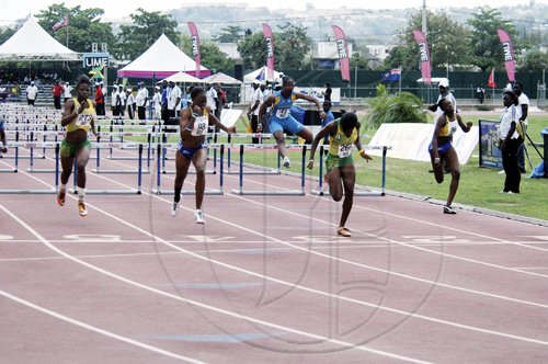 Adrian Frater photo
Jamaica's Yanique Thompson (second right) crosses the finish line to win gold in the Under-17 girls' 100m hurdles final during the LIME CARIFTA Games, at the Montego Bay Sports Complex yesterday.
