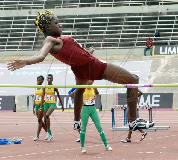 Ian Allen/Staff Photographer
Holmwood Technical's Janieve Russell clears the bar on her way to winning the girls' Class Three High Jump, with a record-breaking leap of 1.77m, on day two of the four-day Inter-Secondary Schools Sports Association (ISSA)/GraceKennedy Boys' and Girls' Athletic Championships, at the National Stadium yesterday.