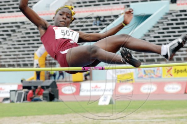 Ian Allen/Staff Photographer
Holmwood Technical's Janieve Russell clears the bar on her way to winning the girls' Class Three High Jump, with a record-breaking leap of 1.77m, on day two of the four-day Inter-Secondary Schools Sports Association (ISSA)/GraceKennedy Boys' and Girls' Athletic Championships, at the National Stadium yesterday.