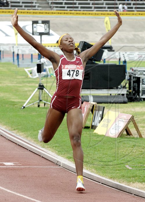 Ian Allen/Staff Photographer
Holmwood Technical High's outstanding Class Three girl, Chris-Ann Gordon, celebrating victory in the 800 metres final on the last day of the GraceKennedy/ISSA Boys' and Girls' Championships at the National Stadium yesterday. Gordon scored a runaway victory in 2:13.45 to help Holmwood to their seventh straight girls' title at the annual championships. MORE ON B1.