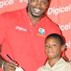 Rudolph Brown/Chief Photographer
West Indies' captain Chris Gayle present a bat to Ronaldo Fletcher student of Excelsior Primary during a Digicel cricket experience at Excelsior High School on Wednesday, June 24-2009