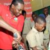 Rudolph Brown/Chief Photographer
West Indies' captain Chris Gayle show students from Excelsior Primary his batting technique during a Digicel cricket experience at Excelsior High School on Wednesday, June 24-2009