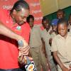 Rudolph Brown/Chief Photographer
West Indies' captain Chris Gayle show students from Excelsior Primary his batting technique during a Digicel cricket experience at Excelsior High School on Wednesday, June 24-2009
