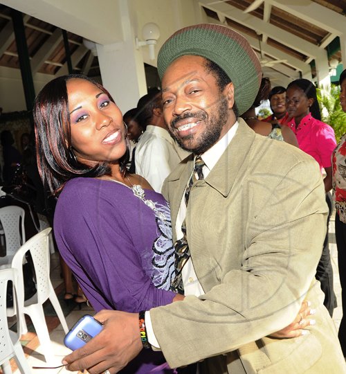 Rudolph Brown/Photographer Donavon Campbell and Roxanne Clacken greet each other warmly.  **********************************************************a have a warm t the St. Catherine Co-operative Credit Union Christmas awards luncheon at Caymanas Golf and Country Club on Wednesday, December 22-2010