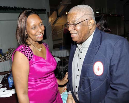 Rudolph Brown/Photographer Donald Jones has a word Yvonne Purcell.   ************************************************************************************ at the St. Catherine Co-operative Credit Union Christmas awards luncheon at Caymanas Golf and Country Club on Wednesday, December 22-2010