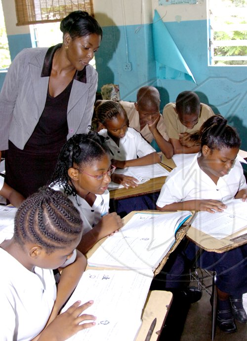 Norman Grindley /Chief Photographer
Kisha Goulbourne a Grade Six Achievement Test teacher at St Aloysius Primary School in Kingston, gave extra lesson to students yesterday, as they try to be ready for next week's exams.