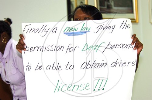 Rudolph Brown/Chief Photographer
Evette Bugridge, (left), Davion Webber and Kathe Lyn, (right) performing a skit driving car for a license at the Island Traffic Authority launches sign language training to enable the testing and certification of deaf drivers at PIOJ, 16 Oxford Road on Wednesday, March 11-2009