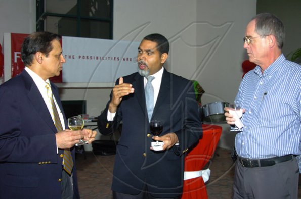 Peta-Gaye Clachar/Staff Photographer
Marco Brito (center) of Symantec makes his point to Farhat Ali (left) CEO and President of Fijitsu America Farhat Ali and Ian Cross the Executive Vice President of Commercials of Fijitsu in the Caribbean at the Fijitsu executive cocktail reception at their Belmont Road office on Thursday, March 12, 2009.