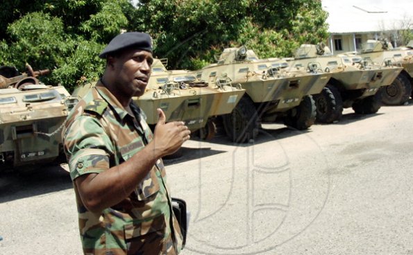 Norman Grindley /Chief Photographer
Major Ricardo Blackwood of the Jamaica Defence Force shows members of the press armoured vehicles during a media open day at Up Park Camp yesterday. Most of the vehicles are inoperable.