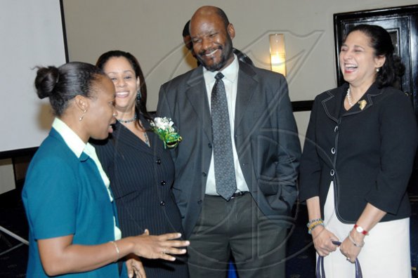 Ian Allen/Staff Photographer
From left: Athinia Campbell (left), projects officer, Paymaster; Natalie St Louis and Dr Maurice McNaughton, chief technology officer, are in  a joyful mood at yesterday's press conference.
*****************************************************************************************
 at the Pegasus Hotel on thursday.