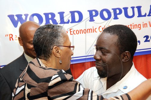 Rudolph Brown/Chief Photographer
Dr. Sheila Campbell- Forrester, Chief Medical Officer in the Ministry of Health greets Ricardo Bennett at the PIOJ/UNFPA World Population Day launch and media sensitization workshop at the Terra Nova Hotel in Kingston on Tuesday, July 14-2009