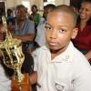 Rudolph Brown/Chief Photographer
Happy mother, Diane Hitchener, (right) and teacher Pearlene  White, (left) smile while Timothy Hitchener of Our Lady of the Angels Prep school walk a way with the winning trophy of the Lay Magistrates Association of Jamaica  National Essay competition 2009 at Holy Cross Church Hall, 17 Half Way Tree Road in Kingston on Wednesday, June 17-2009
Timothy Hitchener of Our Lady of the Angels Prep school with the winning trophy of the Lay Magistrates Association of Jamaica  National Essay competition 2009 at Holy Cross Church Hall, 17 Half Way Tree Road in Kingston on Wednesday, June 17-2009