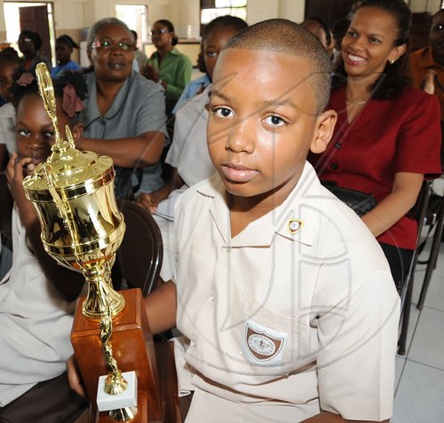 Rudolph Brown/Chief Photographer
Happy mother, Diane Hitchener, (right) and teacher Pearlene  White, (left) smile while Timothy Hitchener of Our Lady of the Angels Prep school walk a way with the winning trophy of the Lay Magistrates Association of Jamaica  National Essay competition 2009 at Holy Cross Church Hall, 17 Half Way Tree Road in Kingston on Wednesday, June 17-2009
Timothy Hitchener of Our Lady of the Angels Prep school with the winning trophy of the Lay Magistrates Association of Jamaica  National Essay competition 2009 at Holy Cross Church Hall, 17 Half Way Tree Road in Kingston on Wednesday, June 17-2009