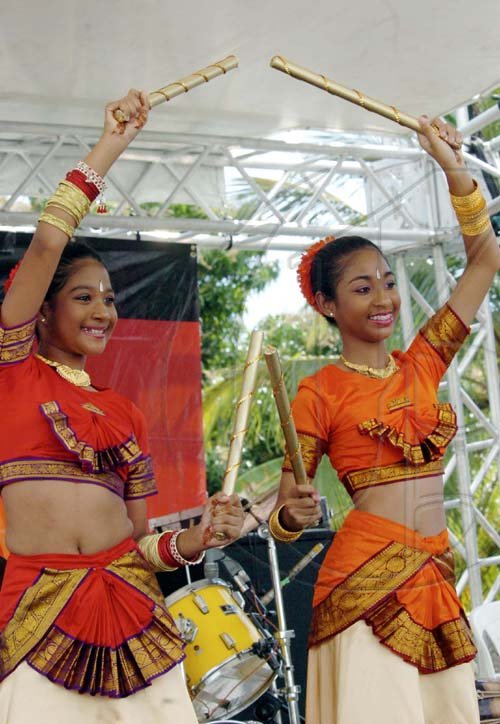 Norman Grindley /Chief Photographer
Rachellle Biersay (left) and Chantelle Biersay perform a stiick dance during the annual Roti festival, held at Lady Musgrave road in St Andrew yesterday.