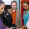 Rudolph Brown/Chief Photographer
Teasca Bennett, (right) Director - Marketing and Sales of Reve Jewellery show her accessories to from left Suzanne and her husband Bruce Bowen, Scotiabank president and CEO, and Patsy Latchman-Atterbury, vice-president of small and medium enterprise (SME) at Scotiabank, at the Small and medium enterprise Scotiabank Thank You reception and party at bank's training centre, 4 Acadia Boulevard on Friday, February 27-2009.