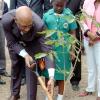 Rudolph Brown/Chief Photographer
Governor General Dr Patrick Allen (left) plants a tree during the launch of the National Tree Growing programme at King's House yesterday while his wife Patricia Allen and Aurian Harris, student of St Martin's Primary School, look on. Also pictured are members of the governor general's security detail.
