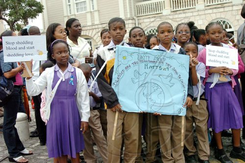 Noel Thompson/Freelance Photographer
Students from Unity Preparatory School bear placards advocating non-violence during Peace Day celebrations in Sam Sharpe Square, Montego Bay, yesterday.


 (Tuesday, March 3, 2009).