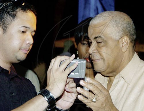 Winston Sill/Freelance Photographer
Dr Parris Lyew-Ayee, director of the Mona GeoInformatics Institute, gives People's National Party Chairman Bobby Pickersgill a crash course in operating the Garmin GPS device on Thursday. You can amp up the navigation potential of your vehicle with this device for a shade above 30 grand.

Launch of Jamaica's first GPS Navigation System, held at the Senior Common Room (SRC), UWI, Mona Campus on Thursday March 5, 2009.