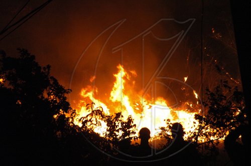 Peta-Gaye Clachar/Staff Photographer
Residents watch as massive bushfires engulfed swathes of hillside in Norbrook, St Andrew, last night. The blaze spread to the backyards of some residences of the upscale community as several screams for help were heard. Two fire trucks battled the hash of fires. 

Fire in Norbrook Heights on Thursday, March 5, 2009.