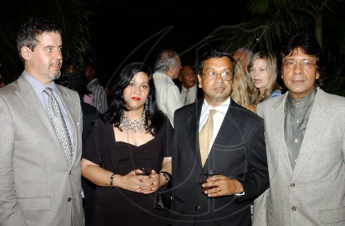 Winston Sill / Freelance Photographer
Dr Badrul Haque (second right) of the World Bank and wife Rubina stop for a photo with Belgian Ambassador Frederic Meurice (left) and Guardsman Group Chairman Kenny Benjamin.
******************************************************************************

 host Reception for Ukraine Ambassador Yuriy Sergeyev, held at Montgomery Road, Stony Hill on Tuesday June 2, 2009.