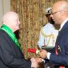 Rudolph Brown/Chief Photographer
Governor General, Patrick Allen (right) invests Desmond Blade with the Order of Jamaica, during the ceremony of investiture and presentation of National Honours and Award looking on Assisting the Governor General is his Aide de Camp, Captain Delando Coriah. at Kings House, St Andrew on Tuesday. May 12-2009