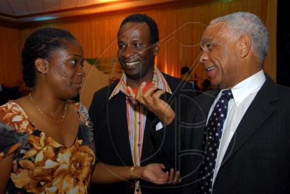 Colin Hamilton/Freelance Photographer 
The Hon. Dr. Omar Davies spends a moment with Jackie Cummings and Patrick Roberts at the Digicel Premier League and National U-21 Awards Ceremony at the Jamaica Pegasus Hotel on Tuesday June 9, 2009.