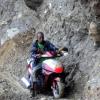 Ricardo Makyn/Staff Photographer.
John Beckford dangerously rides His bike along whats left of a embankment at Friday in the  Rio Grande Valley after Rainfall had caused a Landslide that totally destroyed what was left of the roadway .