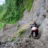 Ricardo Makyn/Staff Photographer.
John Beckford dangerously rides His bike along whats left of a embankment at Friday in the  Rio Grande Valley after Rainfall had caused a Landslide that totally destroyed what was left of the roadway .
