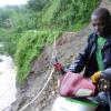 Ricardo Makyn/Staff Photographer.
John Beckford dangerously rides His bike along whats left of a embankment at Friday in the  Rio Grande Valley after Rainfall had caused a Landslide that totally destroyed what was left of the roadway .