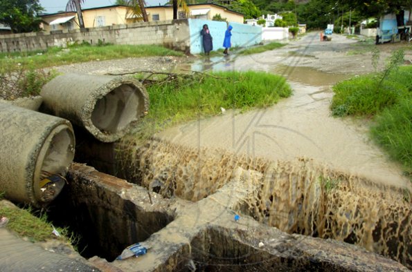 Norman Grindley/Chief Photographer
A broken damaged drain along Stellar Road in Harbour View, St Andrew collects water from yesterday's heavy rainfall.