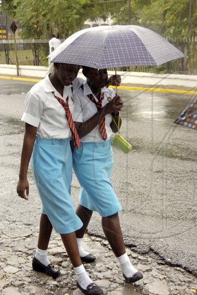 Norman Grindley/Chief Photographer
Students heading home after their orientation at Wolmer's Girls' School in Kingston yesterday. They were seen heading up Marescaux Road after a shower of rain.