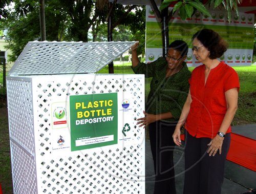 Winston Sill / Freelance Photographer
Scotiabank Group hand over "Receptacles to the University of the West Indies (UWI) Plastic Bottle Recycling Project, and Unveiling of Scotiabank Goes Green",  held at the UWI Centre for Environmental Management, Mona Campus on Tuesday May 18, 2010.  Here are Heather Goldson (left), Senior Vice President, Marketing, Public and Corporate Affairs, Scotiabank hand over one of the Receptacles to Prof Elizabeth Thomas Hope (right), Director, Centre for Environmental Management, UWI.