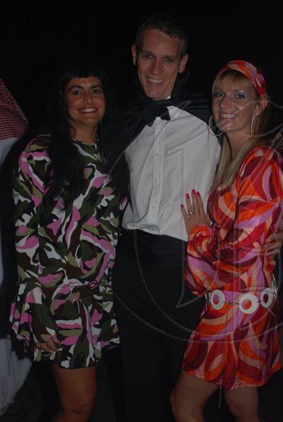 Janet Silvera Photo
 
Count Dracula, Nigel Knowles (centre) wasn't going to allow any ghouls to get neither near his wife Julie (right) nor his sister, Amanda Azan at Groovy Grouper's Halloween party last Saturday night in Montego Bay.