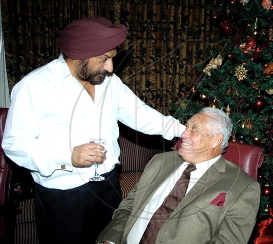 Winston Sill / Freelance Photographer
Mohinder Grover (left), Indian High Commissioner to Jamaica, reasons with a happy looking Transport Minister Mike Henry.

************************************************************************************ Guardsman Group Limited host Christmas Party, Held at their Head Office, Old Hope Road on Friday December 11, 2009. (right).