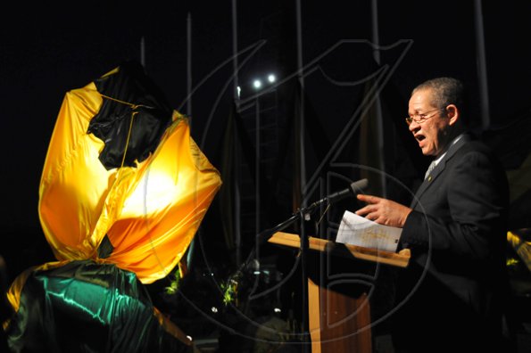 Prime Minister Bruce Golding says a few words before the unveiling of the Herb McKenley monument at National Stadium.