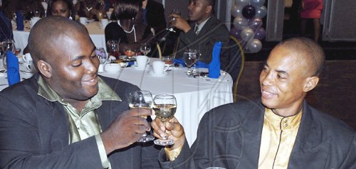 Colin Hamilton/freelance photographer
Top cop Corporal Max Burgher (right),  toasts runner-up top cop,  Constable O Myrie during the Jamaica Constabulary Force awards dinner.

*************************************************************You m