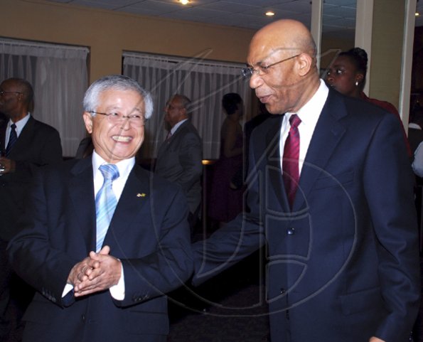 Colin Hamilton/Freelance Photographer
The Japanese Ambassador?Hiroshi Yamaguchi escorts the Governor General Sir. Patrick Allen during the Embassy of Japan hosted a reception in honour of the 76th birthday and 20th year of the reign of the Emperor Akhito at the Pegasus Hotel on December 9, 2009.
