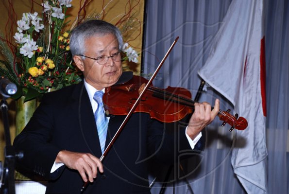 Colin Hamilton/Freelance Photographer
Ambassador?Hiroshi Yamaguchi playing the National Anthem during the Embassy of Japan hosted a reception in honour of the 76th birthday and 20th year of the reign of the Emperor Akhito at the Pegasus Hotel on December 9, 2009.