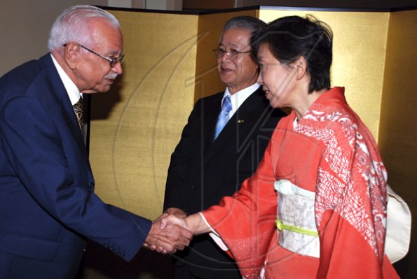 Colin Hamilton/Freelance Photographer
Professor Gerald Laylor is greeted by Mrs. Yoko Yamauchi, the Ambassador looks on during the Embassy of Japan hosted a reception in honour of the 76th birthday and 20th year of the reign of the Emperor Akhito at the Pegasus Hotel on December 9, 2009.