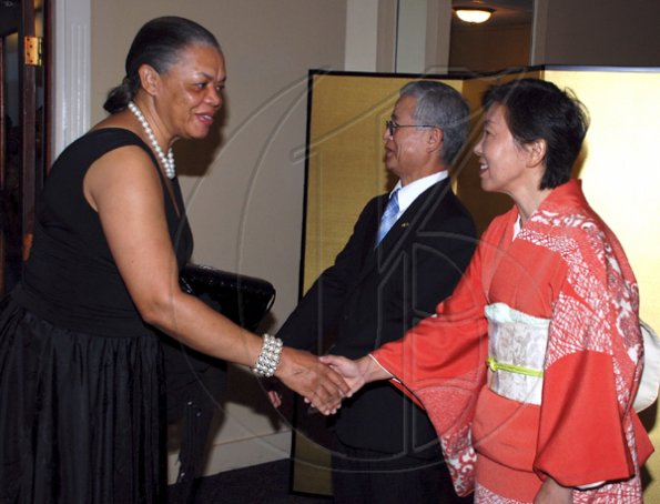 Colin Hamilton/Freelance Photographer
DCP Jevene Bent is greeted by the Ambassadors wife Mrs. Yoko Yamauchi during the Embassy of Japan hosted a reception in honour of the 76th birthday and 20th year of the reign of the Emperor Akhito at the Pegasus Hotel on December 9, 2009.