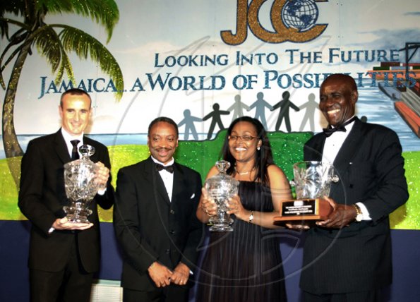 HEADLINE: Best of Chamber

Winston Sill / Freelance Photographer
Representatives of the companies that were selected as the best in their categories by the Jamaica Chamber of Commerce (JCC) are seen here posing with their ?Best of Chamber? awards. From left are Allan Barnes, managing director of Red Stripe/Desnoes and Geddes Limited, which won in the ?Large Enterprise? category; Milton Samuda, president of JCC; Grace Burnett of Allied Insurance Brokers Limited, which got the ?Medium Enterprise? award; and Bernard Williams of Care Furniture Company Limited, ?Small Enterprise? recipient. The presentations were made at the JCC?s annual dinner awards, held at Jamaica Pegasus hotel, New Kingston, Thursday, March 11, 2010.