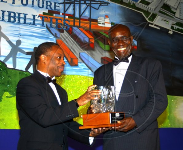Winston Sill / Freelance Photographer
BUSINESS DESK:---Jamaica Chamber of Commerce (JCC) 28th Annual Dinner and Awards Ceremony, held at The Jamaica Pegasus Hotel, New Kingston on Thursday March 11, 2010. Here Milton Samuda (left), President, JCC  presents Bernard Williams (right), of Care Furniture Company Limited with the Best of Chamber: Small Enterprise Award.