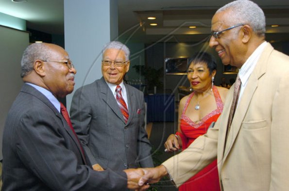 Rudolph Brown/Chief Photographer
Garth Moodie, (right) and his wife Valrie greets by Lloyd Vermont, (left) and Oliver Jones Chairman of JMF at the Jamaica Medical Foundation awards and fund-raising banquet at the Hilton Hotel in New Kingston on Saturday, March 21-2009