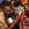 Anthony Minott/Freelance Photographer Joan Edwards, a disabled woman, sings to Delroy Dobney, public cleansing inspector at the National Solid Waste Management Authority during Woody's Restaurant/Transjamaica Highway  sponsored Portmore Mayor's Senior Citizens Christmas treat at the Portmore HEART Academy on Wednesday, December 22, 2010. Over 200 Senior Citizens were feted. Other sponsors include Sovereign Supermarket, TDK tours, and YP Seaton.