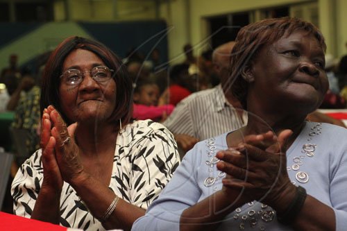 Anthony Minott/Freelance Photographer Two golden agers enjoy Bridgeport High School choir performance during Woody's Restaurant/Transjamaica Highway  sponsored Portmore Mayor's Senior Citizens Christmas treat at the Portmore HEART Academy on Wednesday, December 22, 2010. Over 200 Senior Citizens were feted. Other sponsors include Sovereign Supermarket, TDK tours, and YP Seaton.