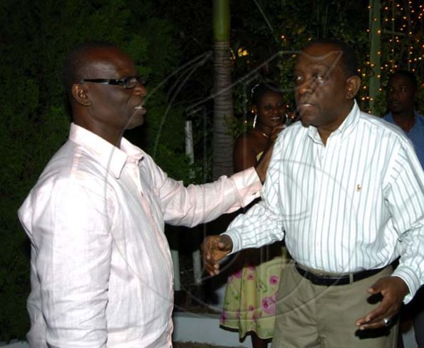 Winston Sill / Freelance Photographer
Mayor of Kingston, Desmond McKenzie (left) escorts friend and fellow 'Labourite' Derrick Smith into the party. McKenzie took over from Smith as a deputy leader of the JLP last year.

host "Mayor's Appreciation Party", held at Eden Gardens, Lady Musgrave Road on Wednesday night December 30, 2009.