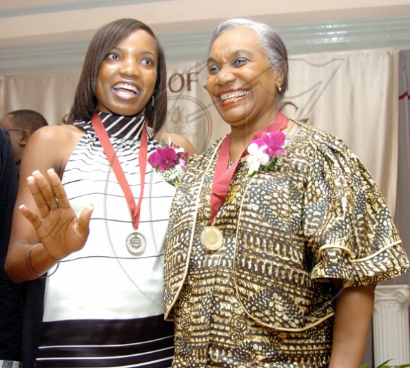 Peta-Gaye Clachar/Freelance Photographer
Youth musgrave awardee Courtney Foster (left) gets familiar with Gold medal awardee Professor Maureen Warner-Lewis at the Institute of Jamaica (IOJ) Musgrave Awards ceremony at the IOJ, downtown Kingston on Wednesday.